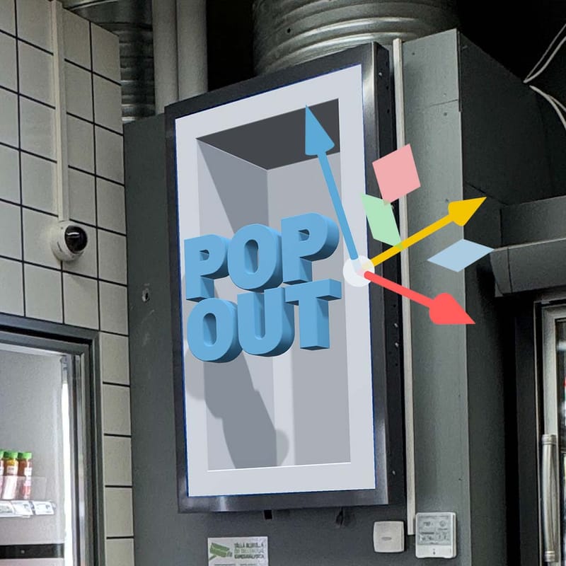 The same screen now showing a recess with the words POP OUT standing out of it, with a move gizmo beside the scene.